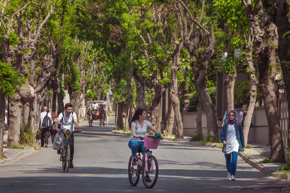 Visitors cycling near the coast on Buyukada in the Prince Islands