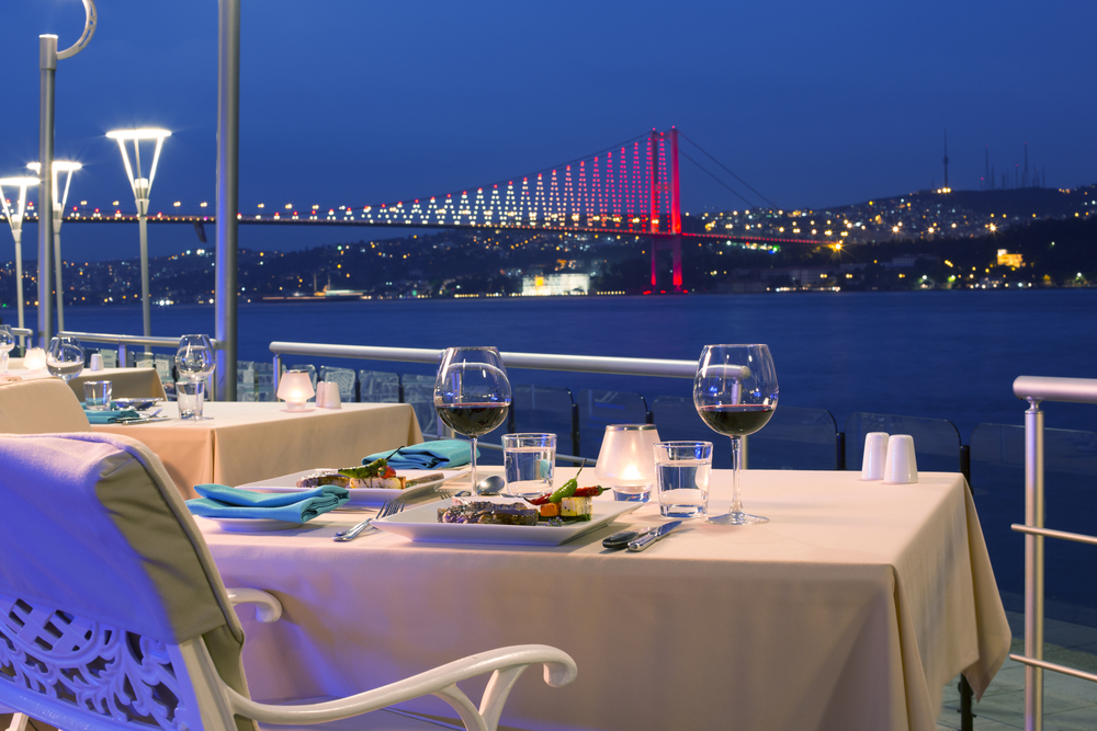 Romantic dinner table setup on a Bosphorus dinner cruise boat in Istanbul at night